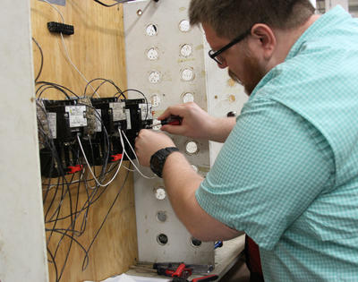Electrical Student Installing Wire in Lab Setting