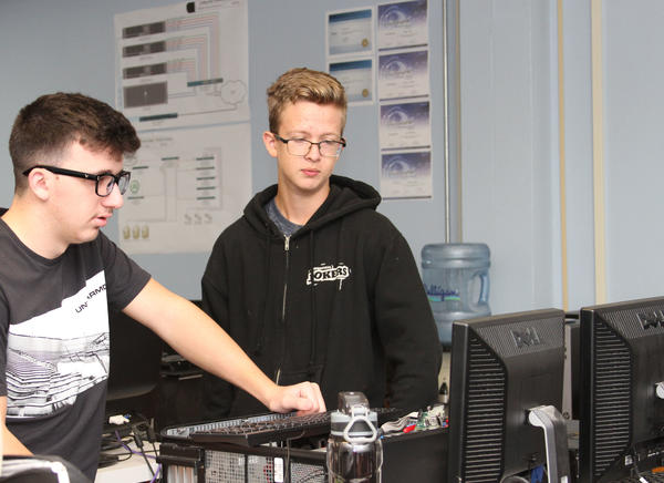 Two Students Working Together to Troubleshoot Computer in Lab