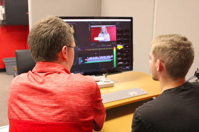 Digital Media Instructor Working With Student on Editing Workstation