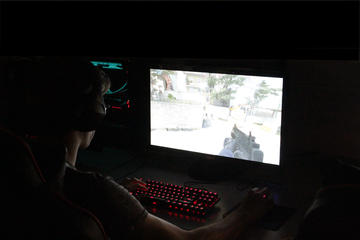 Player playing a pc game in the dark